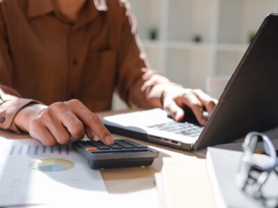 A,Professional,Accountant,Calculating,Financial,Data,Using,A,Calculator,And