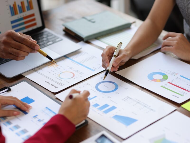 Business,People,Analyzing,Financial,Charts,And,Graphs,,Developing,Investment,Strategy